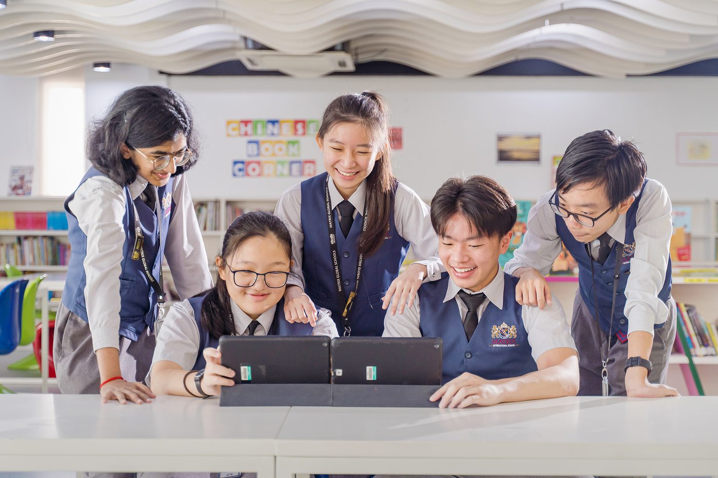 Students collaborating around a tablet